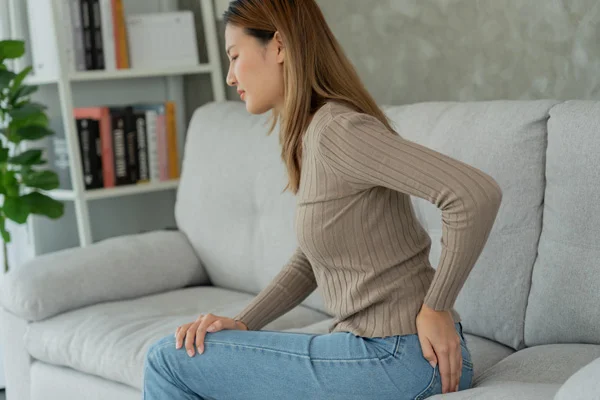 woman rubbing her lower back | Las Vegas Surgical Associates