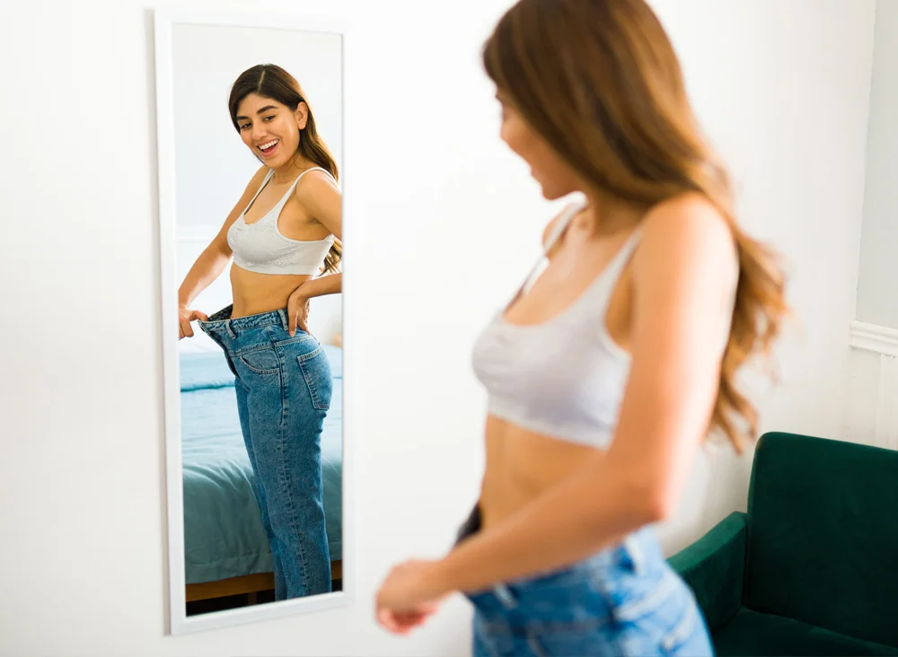 woman looking at herself in the mirror | Las Vegas Surgical Associates