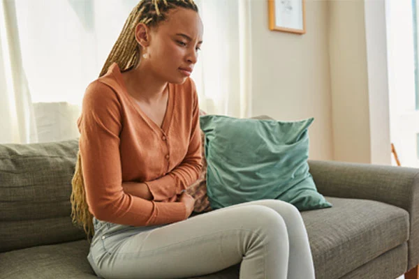 young girl clutching her stomach