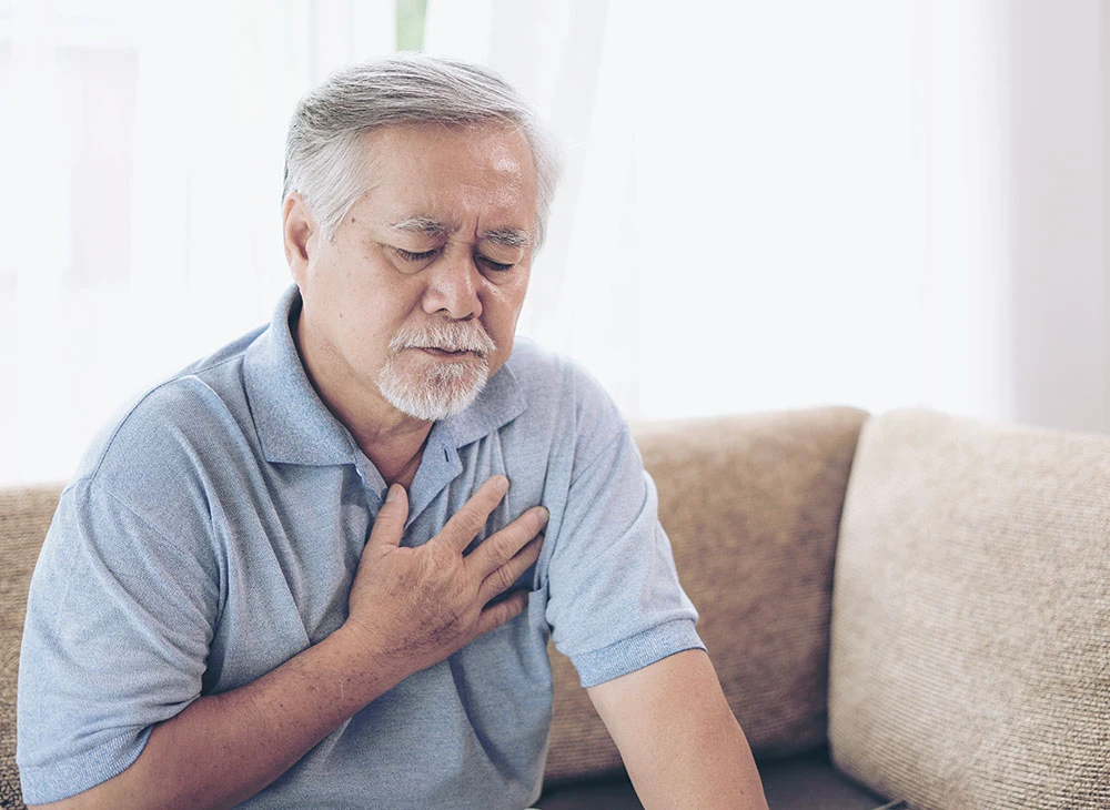 man touching chest in pain | Las Vegas Surgical Associates