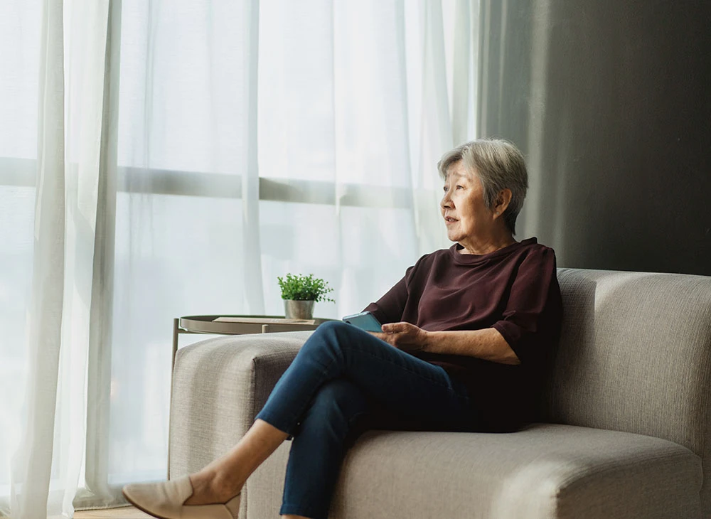 woman sitting on her couch | Las Vegas Surgical Associates