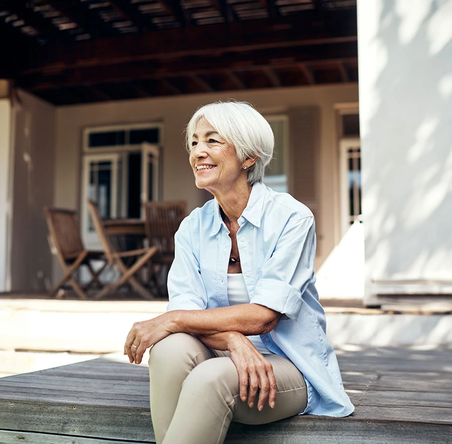 woman sitting on front porch happily | Las Vegas Surgical Associates